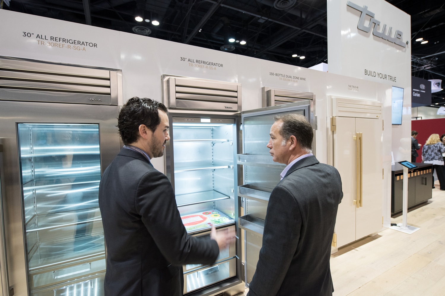 People Viewing Empty Refrigerator Columns - Show Display