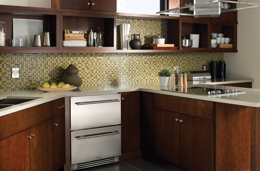 Kitchen Display - Brown Cabinets - Yellow and Green Tile Backsplash - Stainless Steel Undercounter Drawer Refrigerator